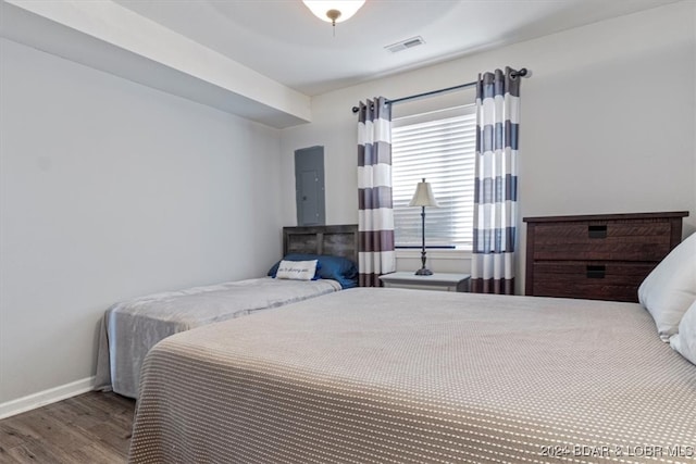 bedroom featuring hardwood / wood-style flooring and electric panel