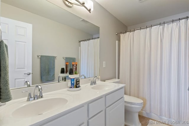 bathroom featuring vanity, toilet, and a shower with curtain