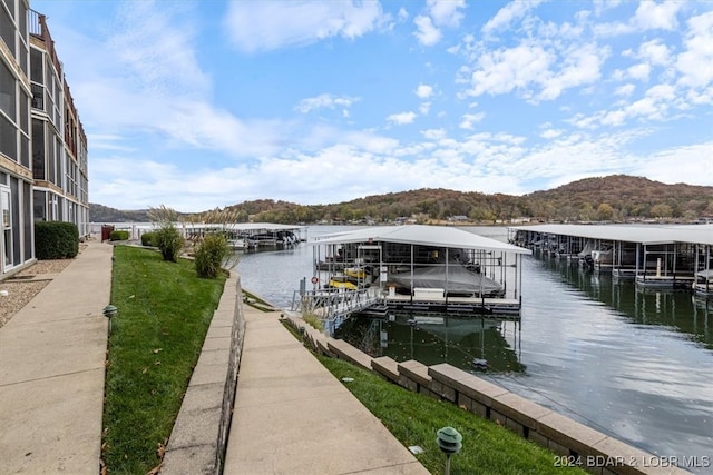 view of dock with a water and mountain view