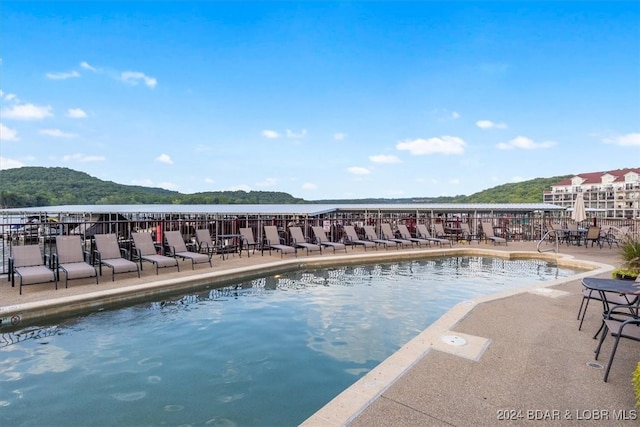 view of pool with a water and mountain view