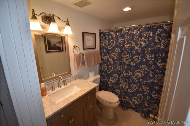 bathroom featuring tile patterned flooring, vanity, and toilet