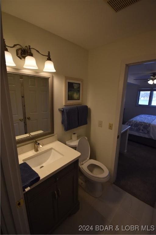 bathroom featuring vanity, tile patterned flooring, toilet, and ceiling fan