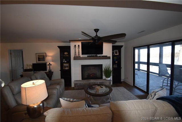 living room with wood-type flooring and ceiling fan