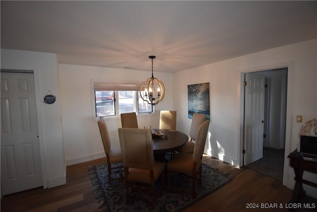 dining room featuring dark wood-type flooring and a notable chandelier