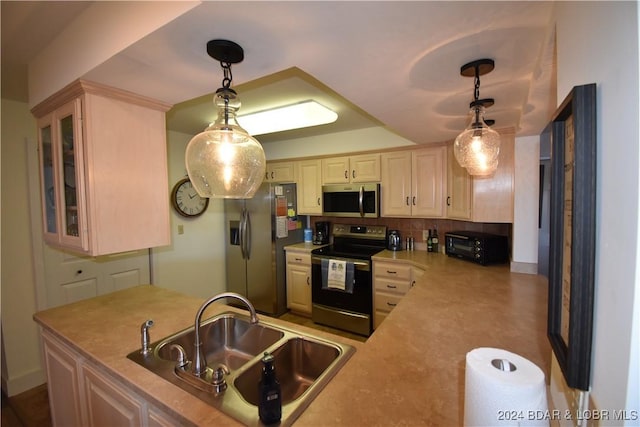 kitchen featuring appliances with stainless steel finishes, sink, decorative backsplash, and decorative light fixtures