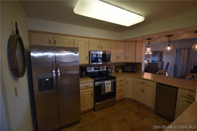 kitchen featuring pendant lighting and stainless steel appliances