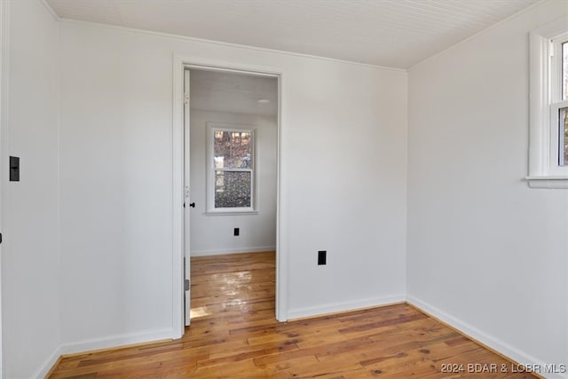 unfurnished room featuring ornamental molding and light wood-type flooring