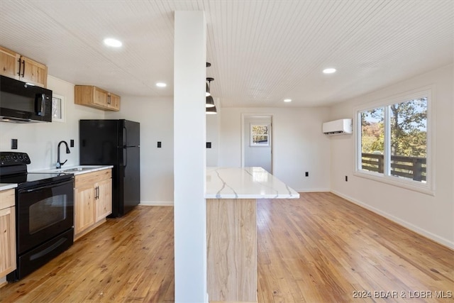 kitchen featuring light brown cabinets, a wall unit AC, light hardwood / wood-style flooring, black appliances, and sink