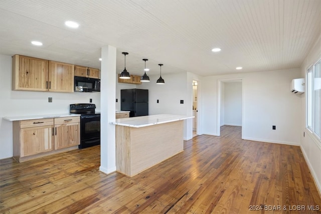 kitchen featuring black appliances, a kitchen island, hardwood / wood-style floors, decorative light fixtures, and a wall mounted AC