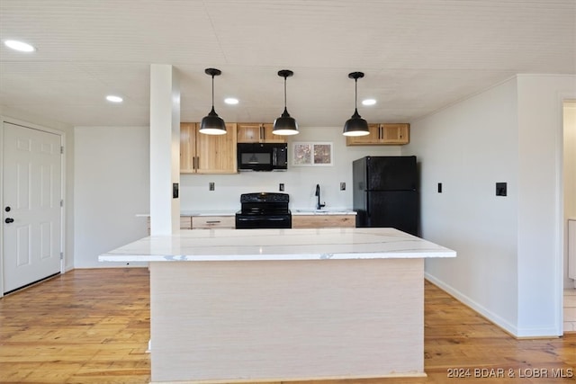 kitchen with light hardwood / wood-style floors, black appliances, light brown cabinets, and hanging light fixtures