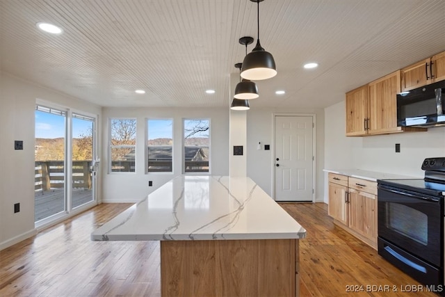 kitchen with light hardwood / wood-style floors, a center island, black appliances, and hanging light fixtures