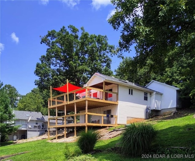 back of house featuring a yard and a deck