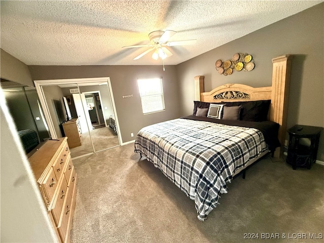 carpeted bedroom with ceiling fan, a textured ceiling, and a closet