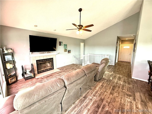 living room featuring a tiled fireplace, ceiling fan, high vaulted ceiling, and wood-type flooring