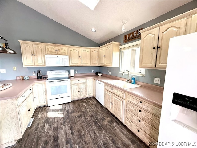 kitchen with light brown cabinetry, white appliances, vaulted ceiling, dark wood-type flooring, and sink