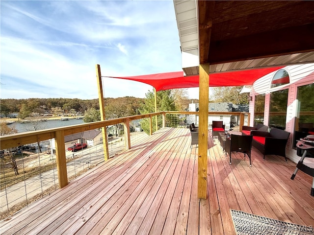 wooden deck featuring an outdoor living space and a water view