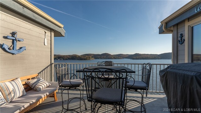 balcony with a water and mountain view