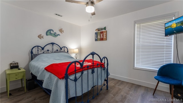 bedroom featuring hardwood / wood-style floors and ceiling fan