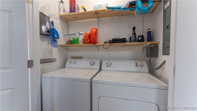 clothes washing area with washer and clothes dryer