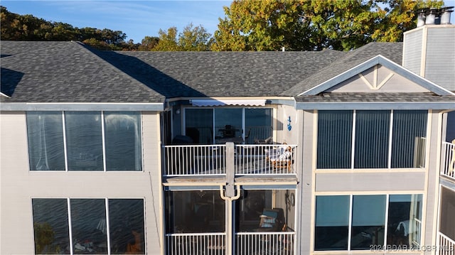 rear view of property featuring a balcony