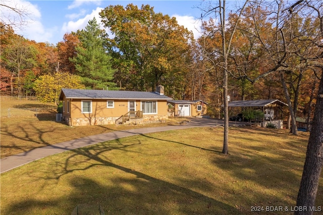 view of front facade with a front yard and central AC unit