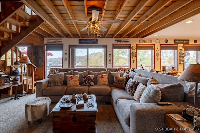 carpeted living room with ceiling fan, wooden ceiling, and beam ceiling