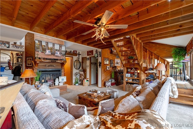 living room featuring ceiling fan, wooden ceiling, carpet flooring, wood walls, and beamed ceiling