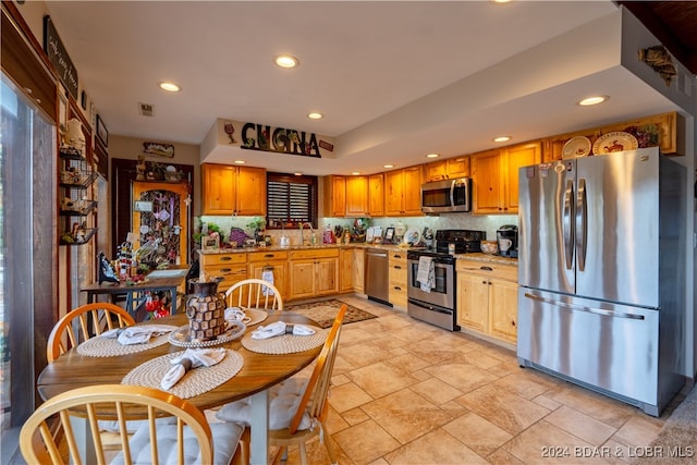 kitchen featuring appliances with stainless steel finishes, decorative backsplash, and sink