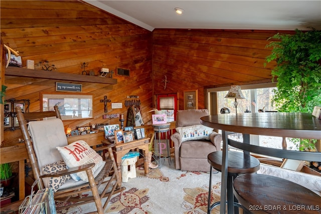 living room with vaulted ceiling and wood walls