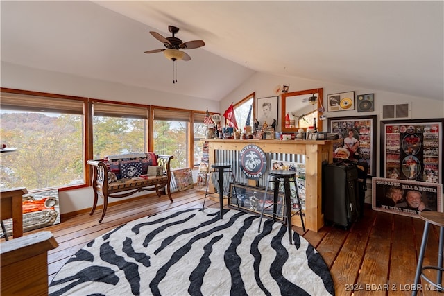 interior space with lofted ceiling, wood-type flooring, and ceiling fan