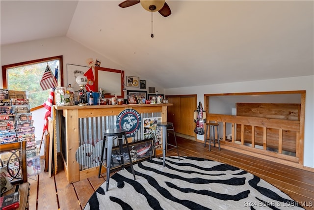 interior space with lofted ceiling, hardwood / wood-style flooring, and ceiling fan