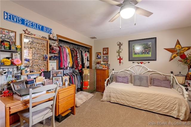 carpeted bedroom featuring a closet and ceiling fan