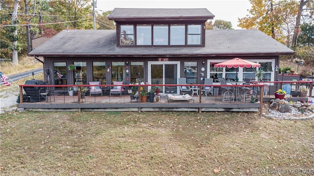 back of house with a yard and a deck