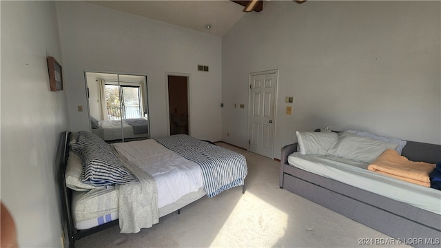 carpeted bedroom with high vaulted ceiling and ceiling fan