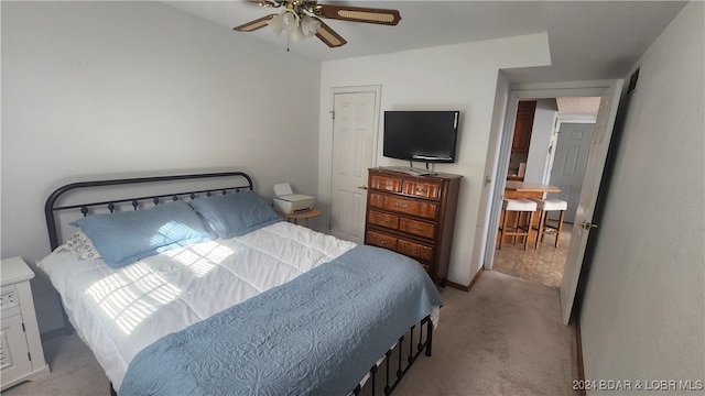 bedroom featuring ceiling fan and light carpet