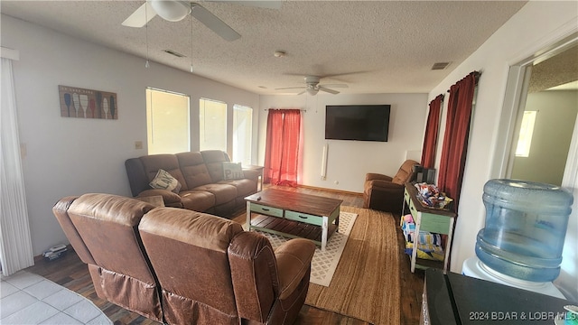 living room with wood-type flooring and a textured ceiling