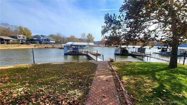 dock area featuring a yard and a water view