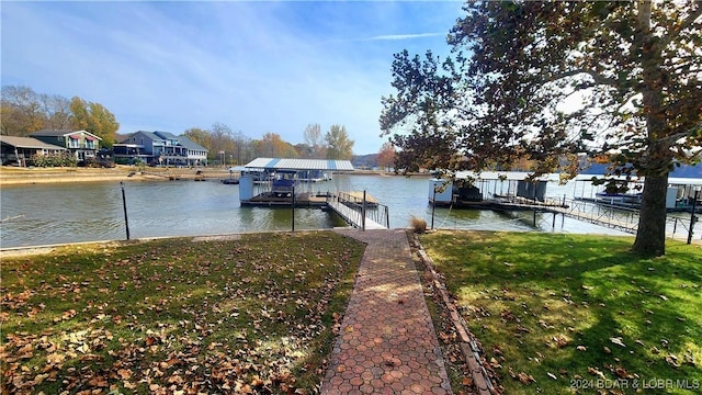 dock area featuring a lawn, a water view, and a residential view