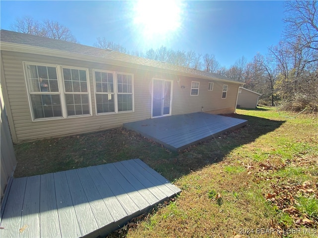 back of house with a yard and a wooden deck