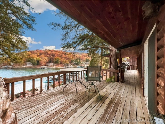 wooden terrace featuring a water view