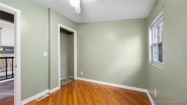 unfurnished bedroom featuring wood-type flooring and ceiling fan