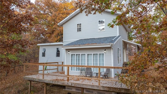 back of house featuring a wooden deck