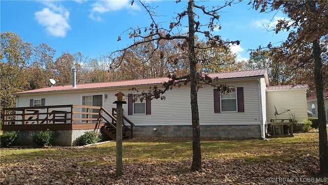 view of front of property featuring a front lawn and a deck