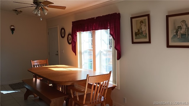 dining area with tile patterned floors and ceiling fan