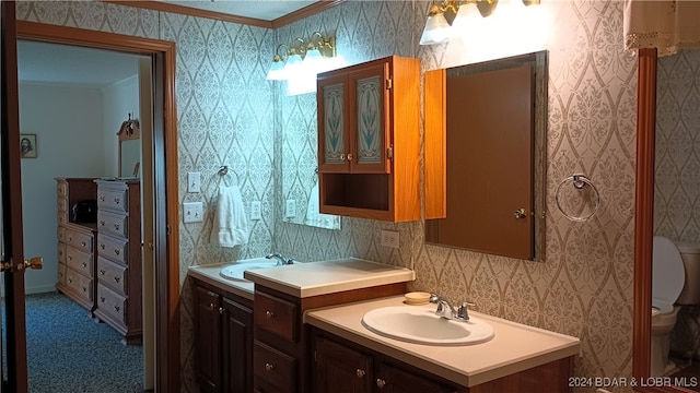 bathroom with vanity, toilet, and ornamental molding