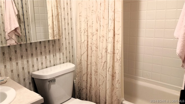 full bathroom with toilet, shower / bath combo with shower curtain, and vanity