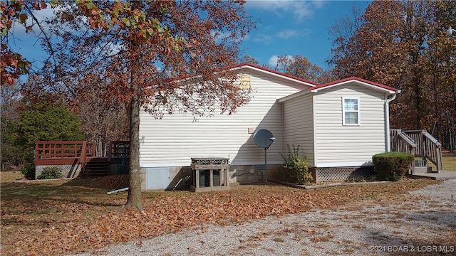 view of side of property with a wooden deck