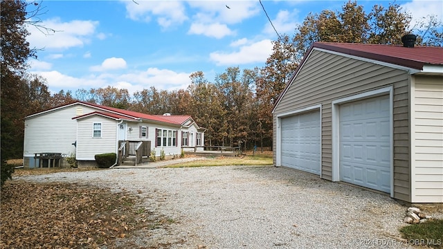 view of side of property with an outdoor structure and a garage