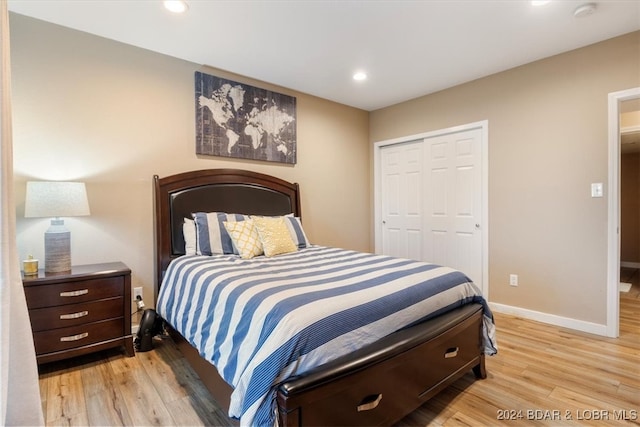 bedroom with a closet and light hardwood / wood-style flooring