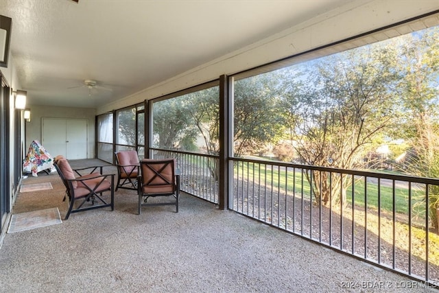 sunroom / solarium featuring ceiling fan